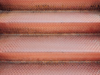 Up and down the stairs.Old stairs made of patterned steel to prevent slipping with copy space. Rusting iron. Rough contact surface