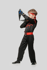 Full photo of ninja boy in kimono ready to throw knife © Denys Kurbatov