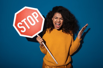 Angry young african woman posing isolated