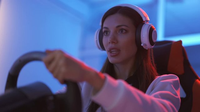 The beautiful woman playing video games in the blue light studio