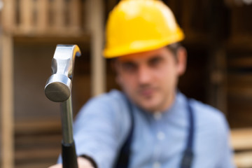 Handsome builder holding hammer