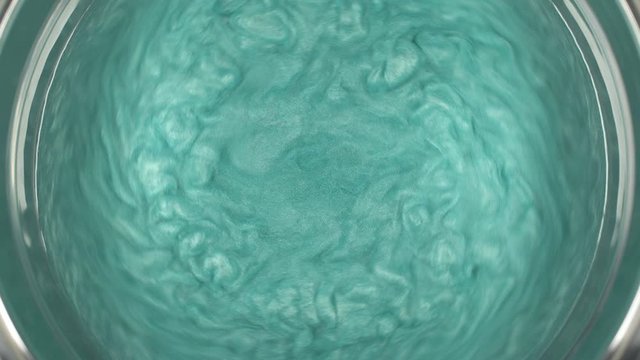 Rheoscopic fluid. Beautiful movement of particles in a liquid. Fantastic patterns and shapes.