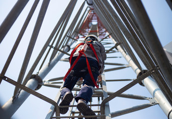 Worker with safety equipment climb high telecom tower for 5G maintenance working,High risk working.