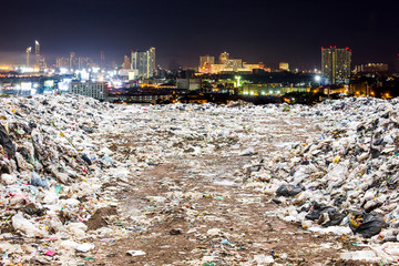 garbage dump and night city , garbage dump pile in trash dump or landfill , environment or global pollution concept