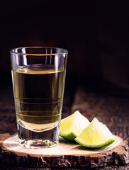 high quality distilled alcohol. Brazilian cachaça (called pinga) taken with lemon, drip, Russian vodka, white rum, vermont, soft tequila, ozo, sake or brandy. Drink on rustic wooden background.