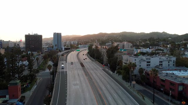 Empty Roads in Hollywood, California during Covid-19 Coronavirus. Aerial drone view of 101-freeway during sunset looking west