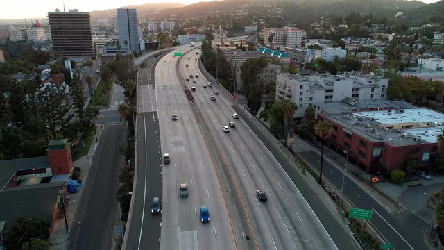 US Hollywood Freeway-101, with no Friday rush hour traffic because of Covid-19 Coronavirus in Los Angeles, California, USA. Aerial drone view towards sunset blvd.