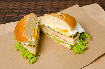 cut chicken burger lies on a paper sheet of paper. showing the filling of a chicken burger