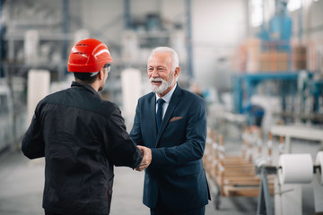 Colleagues working together. Arhitect and worker in factory.	