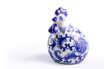 Blue textile flower design on ceramic rooster.