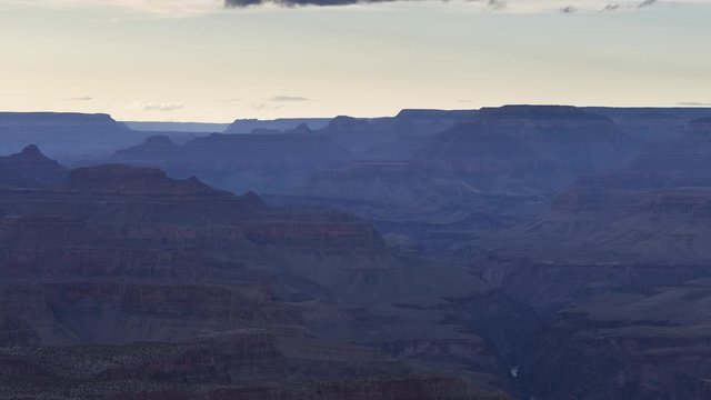 A long-lens golden hour timelapse looking up the Grand Canyon as the sky changes from blue to orange and clouds fly past.