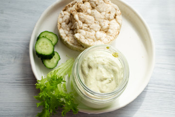 Yogurt with greens and cucumbers for toast for a vitamin spring snack