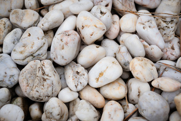 White smooth sea stones scattered with a slide. Background for nautical or home garden postcard