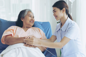 the nurses are well good taken care of elderly woman patients in hospital bed patients  feel...