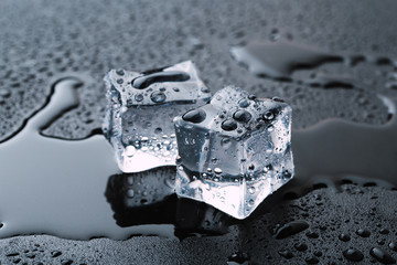 Pyramid of beautiful thawed ice cubes with drops of water