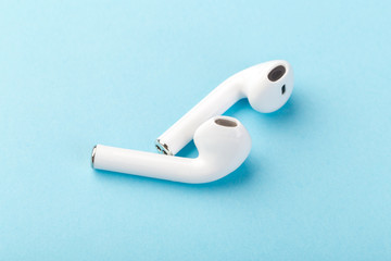 wireless bluetooth headphones lie on a blue background