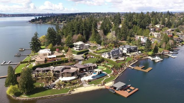 Aerial / drone footage of Eastland waterfront mansions, luxury homes and villas near Medina and Belleview, suburbs of Seattle, Washington during the COVID-19 pandemic