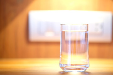 Water in glass on counter background and space for text 