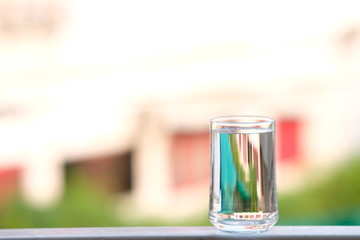 Water in glass on counter background and space for text 