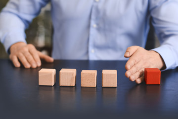 Man removing cube from table. Concept of dismissal