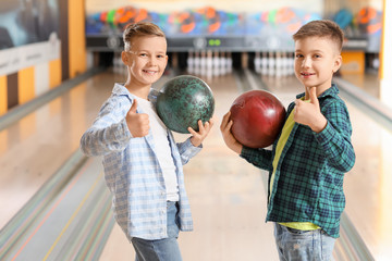Little boys playing bowling in club
