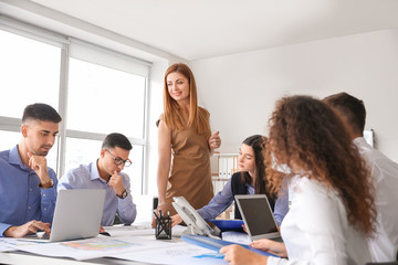 Architect teaching young people in office