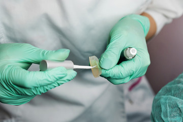 Beautician making eyelash lamination procedures. Modern eyelash care treatment procedures - staining, curling, laminating and extension for lashes. Professional beauty salon.