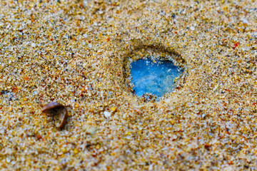 blue water on sand close up