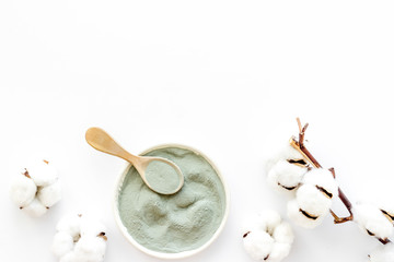 Blue cosmetic clay - face and body skin care - on white background top-down copy space