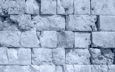 Cracked ancient blue rock wall surface