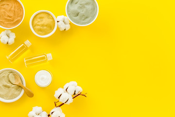 Clays set for face mask on yellow background top-down frame copy space