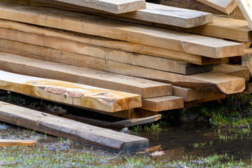 Wooden planks, lumber. Pine natural wooden boards on the site. Outdoor boards.