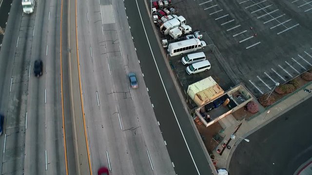 Aerial drone view tilting up towards Downtown Los Angeles from Hollywood Freeway with no traffic during Covid-19 Coronavirus outbreak lockdown in California, USA.