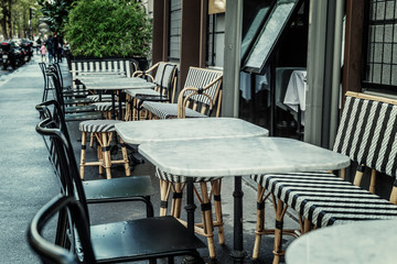Street cafe with empty tables on a cloudy day. Close-up.