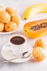Traditional Brazilian breakfast - cheese bread, coffee, ripe fruit.