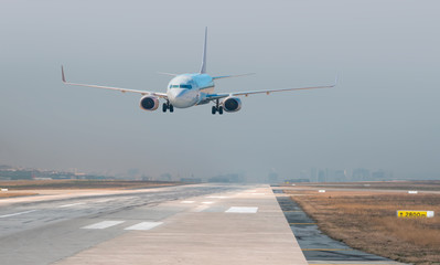 Fototapeta premium White Passenger plane fly up over take-off runway from airport 