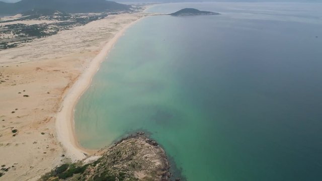 Aerial of Hon Ngang Beach at Dam Mon Peninsula, Van Phong Bay, Van Ninh, Khanh Hoa. 80km north of Nha Trang, is beautiful with its 10km untouched wilderness white sandy beach and crystal clear water