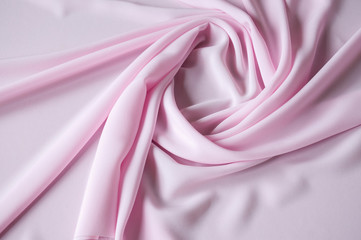 Obraz premium Pink fabric background with beautiful pleats