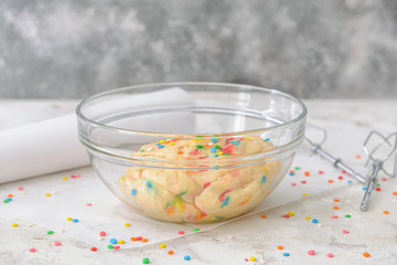 Bowl with sweet dough on table