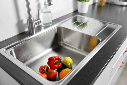 Hygiene, Food And Safety Concept - Fruits And Vegetables In Stainless Steel Kitchen Sink