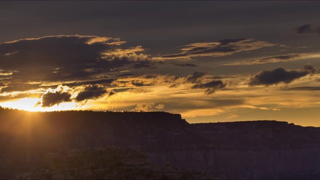 A long-lens sunset timelapse looking at the sun setting below the South Rim of the Grand Canyon.