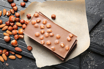 Sweet chocolate with nuts on dark background