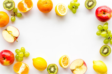 Oranges, lemon, apple, kiwi and grape - healthy food concept with fruits - on white background...