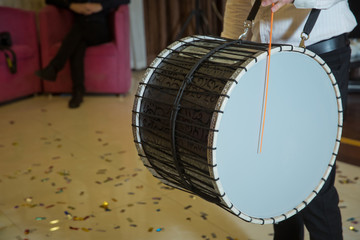 Musicians march, play and make music with large bass drums . Drummer performance musicians play the...