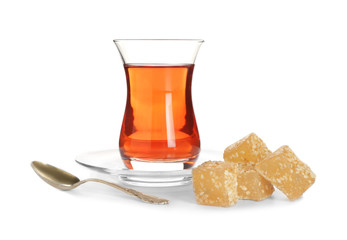 Tasty Turkish tea with sweets on white background