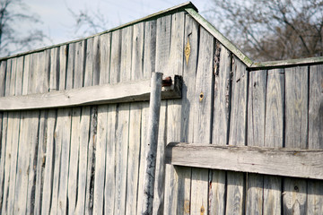 Old wood fence with a country farm, blue sky. Sping minimal concept. Nature background.