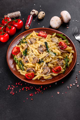 Pasta with mushrooms, cheese, spinach, rukkola and cherry tomatoes