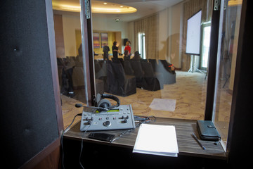translators cubicle . interpreting - Microphone and switchboard in an simultaneous interpreter...