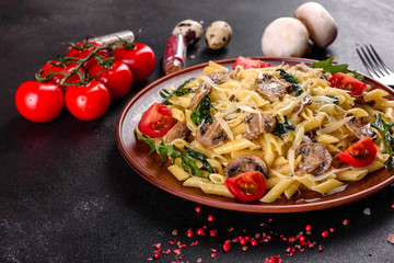 Pasta with mushrooms, cheese, spinach, rukkola and cherry tomatoes