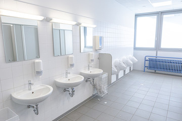 Fototapeta na wymiar Toiletten mit Waschbecken in einem gefliesten Raum